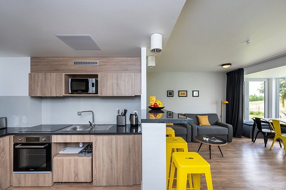 Accessible apartment living room with kitchenette and space for a wheelchair