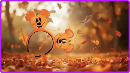 Pumpkin Mickey ear headband against a golden autumn backdrop